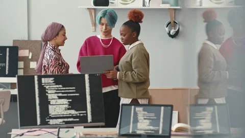 Team of Young Diverse Software Developers Talking at Workplace Stock Footage 241267120