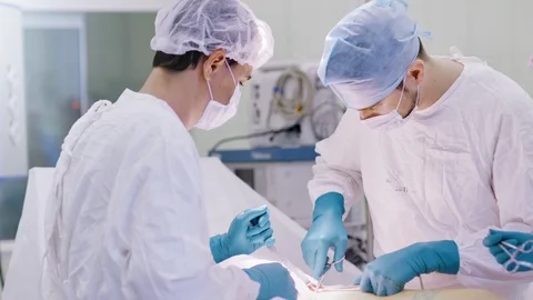 Team of young doctors or student or intern performing operation using medical Stock Footage 99658423