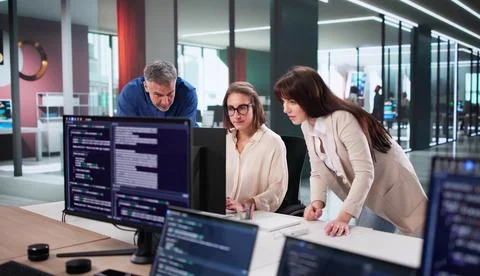 Team Of Young Engineers Work Together To Develop Cutting-edge Software. A Wom Foto stock