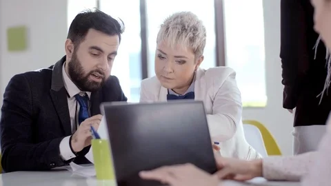 A team of young hardworking people, of different races, plan to start their new Stock Footage 123712376