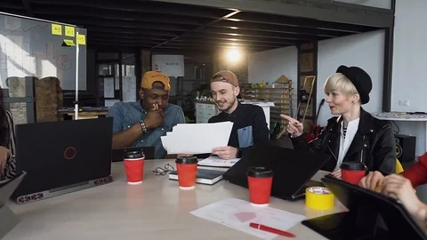 Team of young hipster working together on the new business plan. Stock Footage 108316737