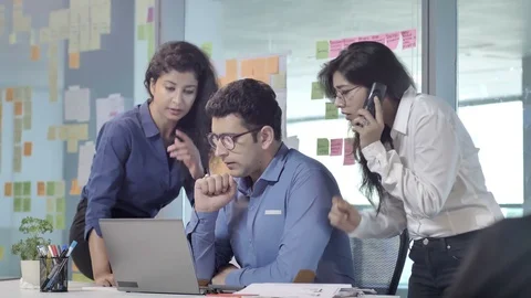 A team of young Indian office executives or workers working on a project Stock Footage 87863752