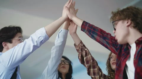 Team of young professionals giving a group high five Stock Footage 331866300