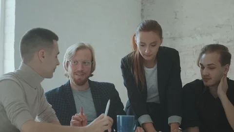 A team of young professionals is working closely together discussing the project Stock Footage 119109888
