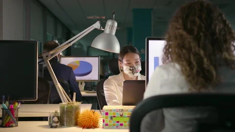 Team of Young Professionals Working Late in Office in Protective Face Masks Stock Footage 132429356