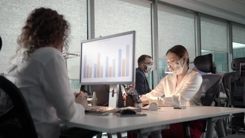 A Team of Young Professionals Working Late in Office in Protective Face Masks Stock Footage 132430093