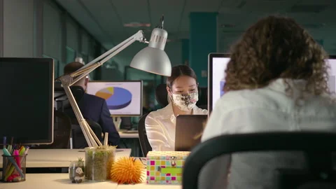 Team of Young Professionals Working Late in Office in Protective Face Masks Stock Footage 132431363