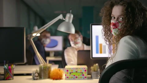 Team of Young Professionals Working Late in Office in Protective Face Masks Stock Footage 132431613