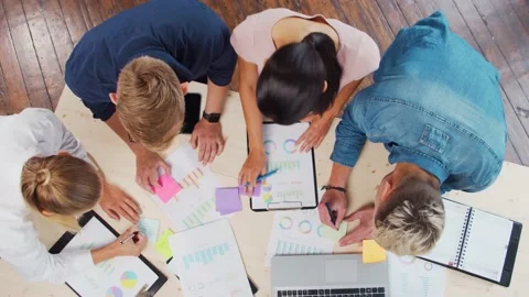 Team of young startupers is working at the table in the office, discussing the Stock Footage 160800951