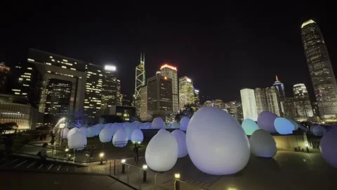 TeamLab Light Installation at Night with Hong Kong Skyline in Background Stock Footage 306762250
