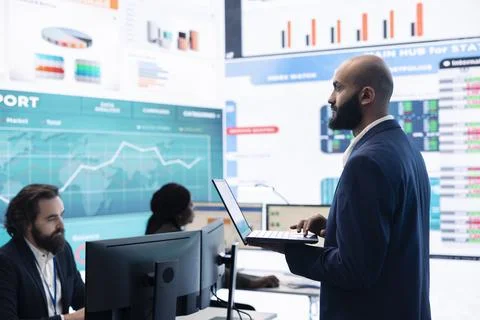 Teammates and manager assembling in a big data room to go over their results Stock Photos