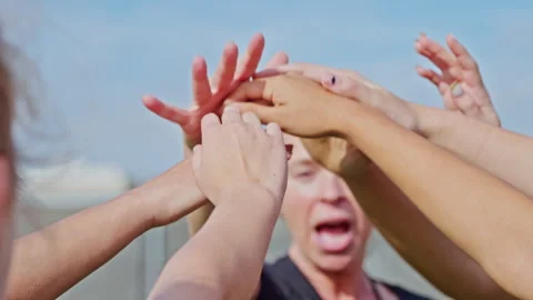 Teammates bring in their hands for a cheer before a game Stock Footage 305293957