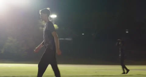 Teammates practicing bowling on cricket field, keeper sprinting retrieving ball, Stock Footage 341851452