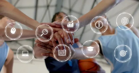 Teammates stacking hands in huddle revealing animated analytics icons around 動画素材 317406918