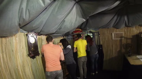 Teammates working together trying to find clues to exit the real escape room gam Stock Footage 68827451