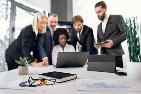 Teamwork, brainstorming in office. Focus on papers with financial carts Stockfoto's