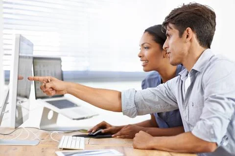 Teamwork, computer or web developers with research or news in office for helping Stock Photos