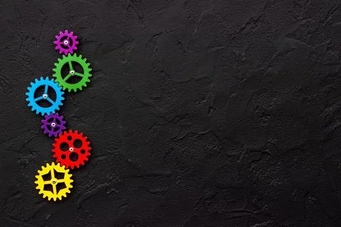 Teamwork concept. Gears connect in working mechanism, overhead view Stock Photos