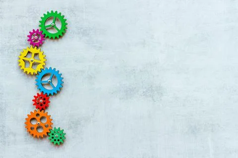 Teamwork concept. Gears connect in working mechanism, overhead view Stock Photos