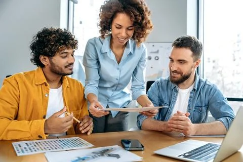 Teamwork concept. A group of positive multiracial creative successful designers Stock Photos