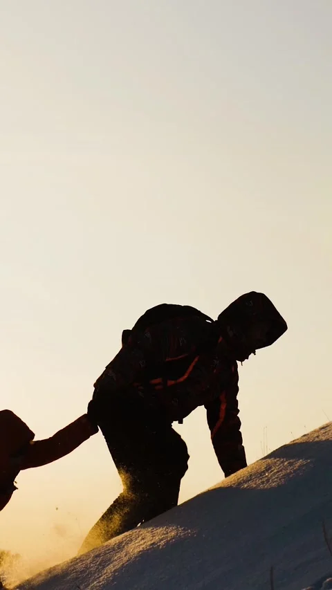 Teamwork concept. help you partner climb snowy mountain with backpack. hiking Stock Footage 275032041