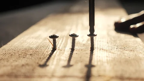 Teamwork concept. man the worker tightens the screw with a screwdriver. Screws Stock Footage 112238772