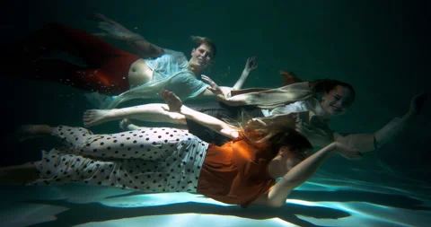 Teamwork concept. Three fun happy young beautiful business women swim smiling at Video stock 171860758