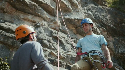 Teamwork. Concept of victory, working with a partner. Two climbers celebrate Stock Footage 272819285