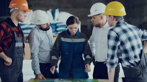 Teamwork of construction engineers studying the plan of an object at a Stock Footage 136357281