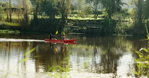 Teamwork, couple and rowing in kayak in river on holiday, vacation and travel Stock Footage 254960093