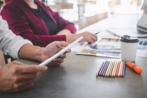 Teamwork of creative designers working on new project and choose color swatch Stock Photos
