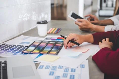 Teamwork of creative designers working on new project and choose color swatch Stock Photos