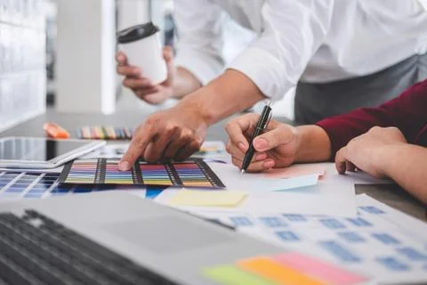 Teamwork of creative designers working on new project and choose color swatch Stock Photos