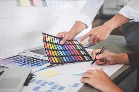 Teamwork of creative designers working on new project and choose color swatch Stock Photos