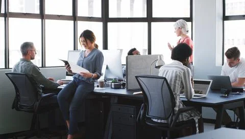 Teamwork, creative people and discussion in office with proposal, tech and .. Stock Photos