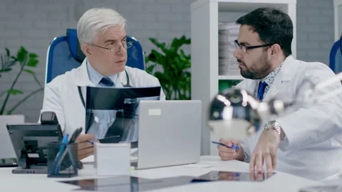 Teamwork of doctors in the office. X-ray consultation. Stock Footage 151329629