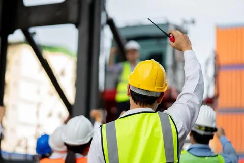 Teamwork engineer technician and foreman and safety helmet in cargo container Foto stock