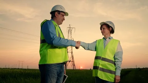 Teamwork engineers, partners shaking hands, good work. Team of power engineers Stock Footage 307550349