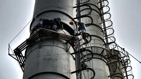 Teamwork of fitters to install a smoke pipe Stock Footage 249527074