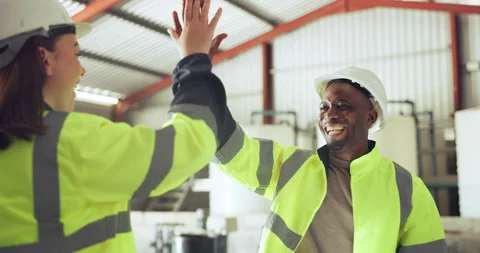 Teamwork, high five and construction worker people in a warehouse for success or Stock Footage 255274168