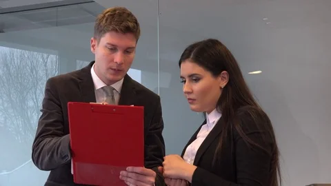 Teamwork inside office young entrepreneurs salesman saleswoman read note discuss Stock Footage 84317371