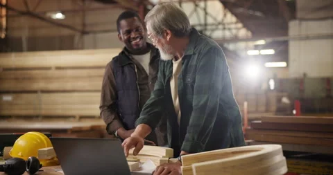 Teamwork, laptop in workshop and handshake, apprentice and designer furniture Stock Footage 285852826