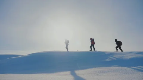 Teamwork. men tourists climbing walking top mountains rocks peak group team Stock Footage 103184545