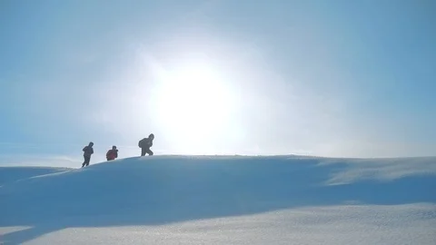 Teamwork. men tourists climbing walking top mountains rocks peak group team Stock Footage 106533930