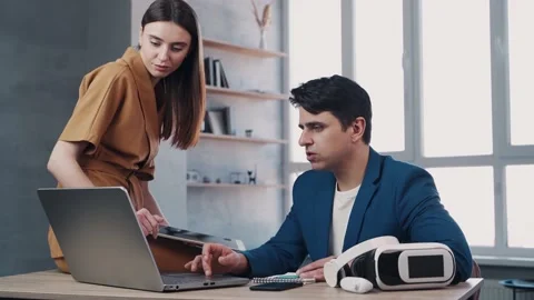 Teamwork in modern office, man and woman managers look at the laptop screen and Stock Footage 153607471