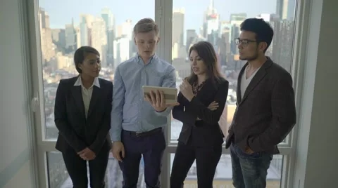 Teamwork of multi ethnic group analyzing together business strategy in office  Stock Footage 62567430