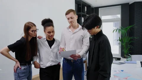 Teamwork in the office. Four employees communicate Stock Footage 219460503