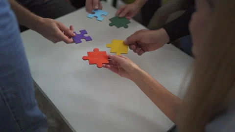 Teamwork of partners. Concept of integration and startup with puzzle pieces Stock Footage 153056489