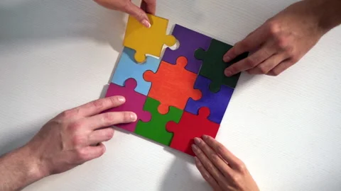 Teamwork of partners. Concept of integration and startup with puzzle pieces Stock Footage 153058861