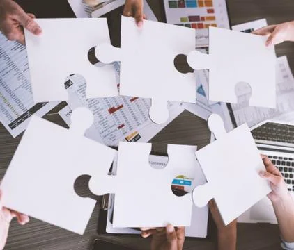 Teamwork of partners. Concept of integration and startup with puzzle pieces Stock Photos